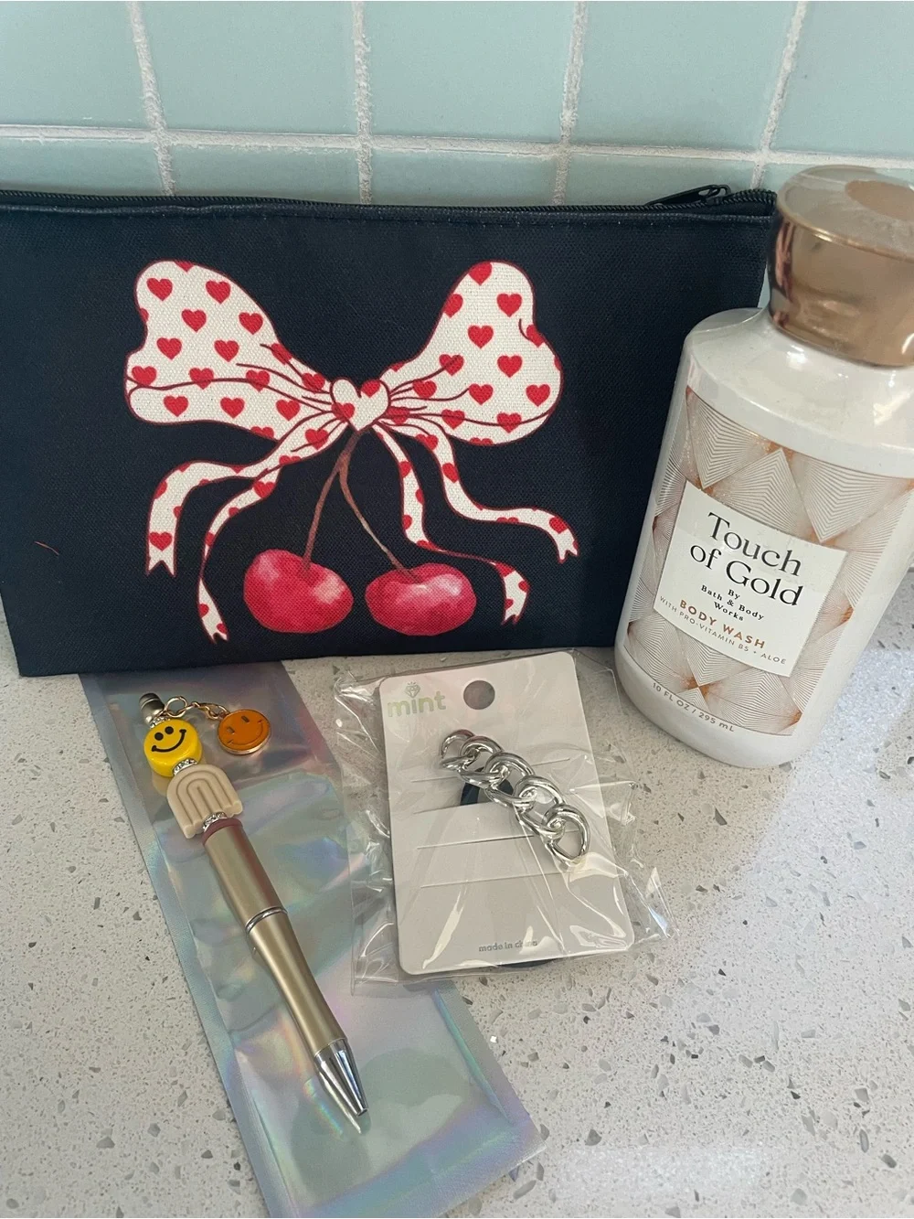 Black Cosmetic Bag Red Cherry Bow Design. Includes body wash, pen, and hair tie - Picture 2 of 2